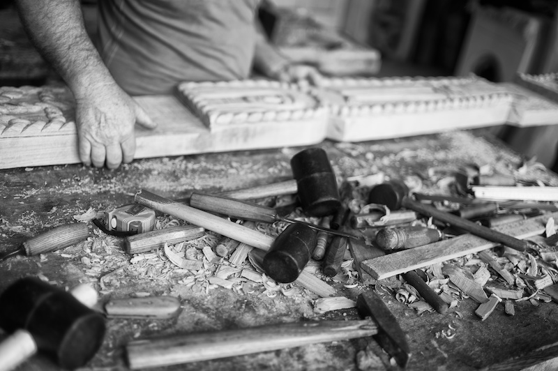 A wood carver and his traditional tools in Maramures,Romania